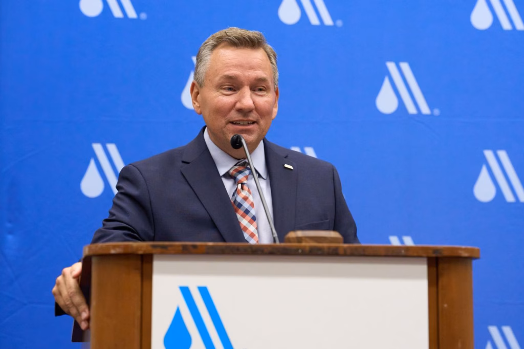 A man speaks at a podium.