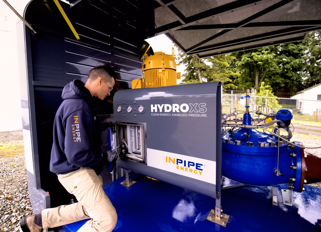 A man works on a micro-hydropower system.