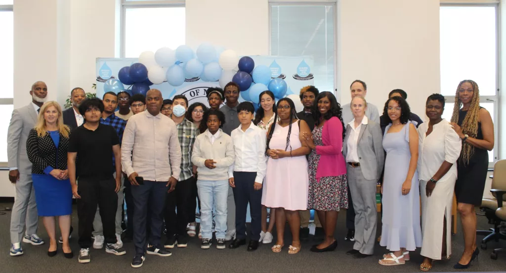A group of students pose for a photo at a graduation ceremony.