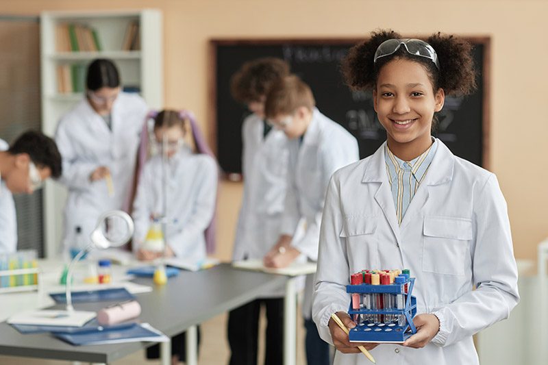 Waist,Up,Portrait,Of,Black,Teen,Schoolgirl,Wearing,Lab,Coat