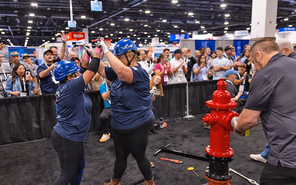 Two women high-five after a competition at ACE.