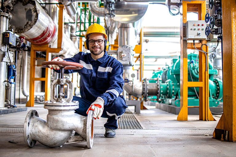 Portrait,Of,Industrial,Worker,Standing,By,High,Pressure,Valve,Inside