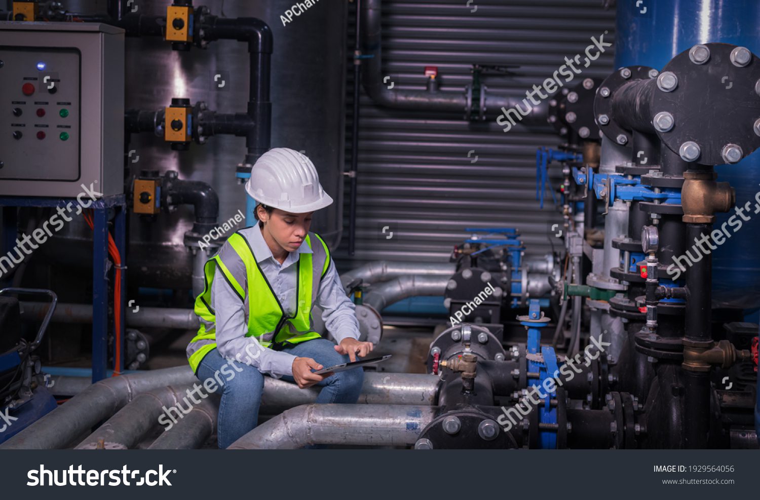 stock-photo-industry-engineer-under-checking-the-industry-cooling-tower-air-conditioner-is-water-cooling-tower-1929564056